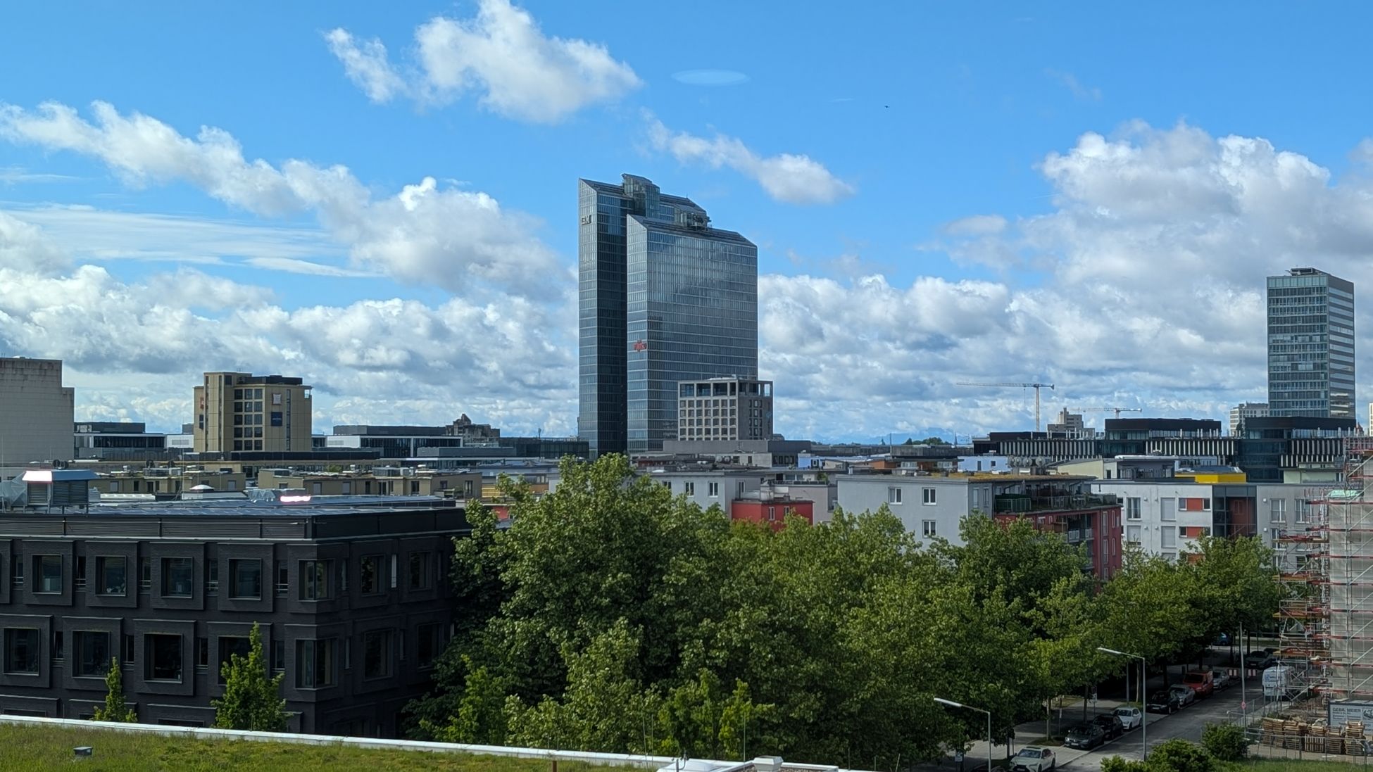 Immobilienmakler Schwabing: Ausblick auf ein Hochhaus mit blauem Himmel im Hintergrund